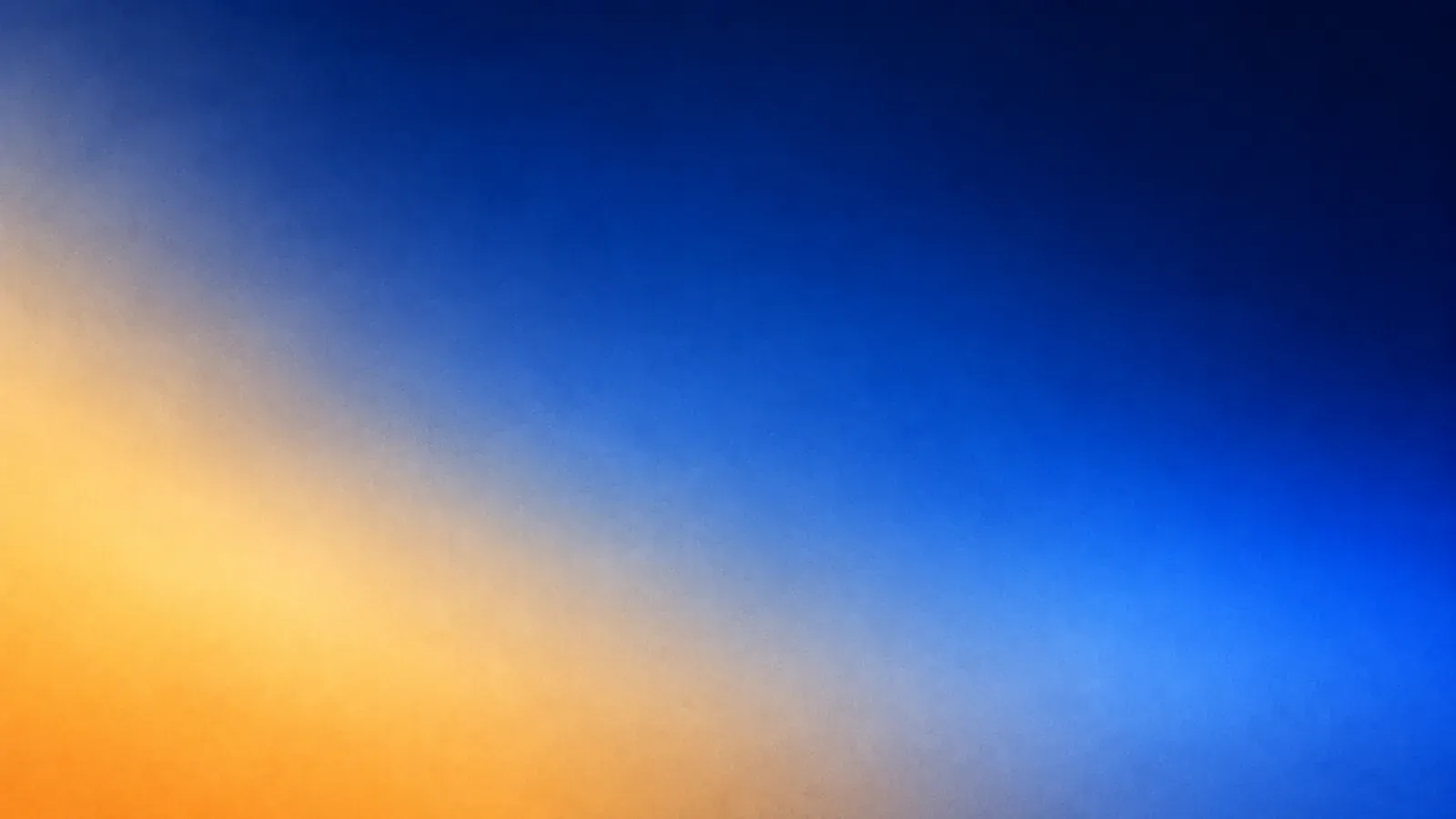 A soft blur of light: warm amber in the lower left, sweeping diagonally into deep blue at the upper right.